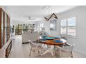 Bright dining room with round wooden table and four chairs, view into living room and kitchen at 512 W Venice Ave # 401, Venice, FL 34285