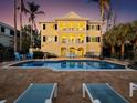 Inviting heated pool with patio furniture, overlooking the ocean at sunset at 6161 Gulf Of Mexico Dr, Longboat Key, FL 34228