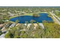 Bird's eye view of a house near a lake and golf course at 6525 Berkshire Pl, University Park, FL 34201