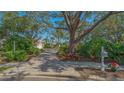 Brick driveway leading to a house with lush landscaping at 6525 Berkshire Pl, University Park, FL 34201