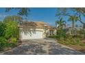 Single story house with white garage door and manicured landscaping at 6525 Berkshire Pl, University Park, FL 34201