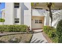Condo building exterior showcasing entrance and landscaping at 760 Village Cir # 109, Venice, FL 34292