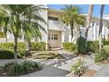 Condo building exterior with lush landscaping and walkway at 760 Village Cir # 109, Venice, FL 34292