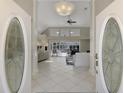 Elegant entryway with double doors, tile flooring, and view to the living room at 8365 Shadow Pine Way, Sarasota, FL 34238