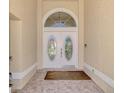 Charming entryway with double doors and arched window at 8365 Shadow Pine Way, Sarasota, FL 34238
