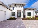 White modern home with dark entry door at 8367 Sea Glass Ct, Sarasota, FL 34240