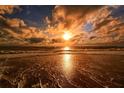 Stunning sunset over the ocean with waves on the shore at 8779 Midnight Pass Rd # 504H, Sarasota, FL 34242
