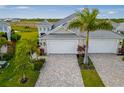 Two-unit building with attractive paver driveway and landscaping at 226 Van Gogh Cv, Bradenton, FL 34212