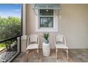 Relaxing screened porch with wicker chairs and a small table at 226 Van Gogh Cv, Bradenton, FL 34212