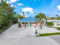 Cute cottage with turquoise accents and white picket fence at 229 Shore T Rd, Nokomis, FL 34275