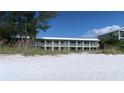 Beachfront building with balconies overlooking the white sand beach at 2310 Gulf N Dr # 205, Bradenton Beach, FL 34217