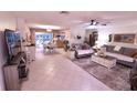 Open concept living and dining area with tile floors and access to backyard at 2426 Nassau St, Sarasota, FL 34231