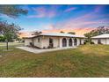 Single story home with a spacious lawn and sunset view at 430 Botticelli Dr # 430, Nokomis, FL 34275