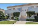 Attractive building entrance with landscaping and stairs at 5218 Wedgewood Ln # 72, Sarasota, FL 34235