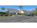 Exterior view of the building with parking and landscaping at 5218 Wedgewood Ln # 72, Sarasota, FL 34235