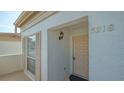 Well-maintained condo building entrance with a tan door at 5218 Wedgewood Ln # 72, Sarasota, FL 34235