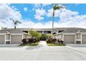 Condo building exterior showcasing landscaping and walkway at 5330 Hyland Hills Ave # 2311, Sarasota, FL 34241
