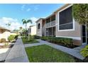 Pathway with lush landscaping, leading to condo entrances at 5330 Hyland Hills Ave # 2311, Sarasota, FL 34241