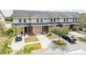 Townhouse community with a pond view and parking at 5809 Leopardstown Dr, Tampa, FL 33610