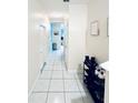 Bright hallway with tile floors and shoe storage at 5809 Leopardstown Dr, Tampa, FL 33610