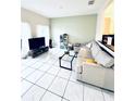 Spacious living room with tile floors and comfy seating at 5809 Leopardstown Dr, Tampa, FL 33610