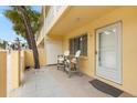 Condo building exterior with a private patio and seating area at 5955 Midnight Pass Rd # 4E, Sarasota, FL 34242