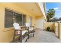 Private condo patio with two chairs, creating a relaxing space at 5955 Midnight Pass Rd # 4E, Sarasota, FL 34242