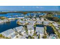 Aerial showing waterfront homes, landscaping, and community pool at 1005 Ibis Ct, Bradenton, FL 34209