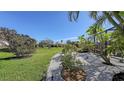 Landscaped backyard with gravel pathways and tropical plants at 10656 Glencorse Ter, Bradenton, FL 34211