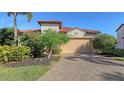 Single-story home with tile roof, attached garage, and lush landscaping at 10656 Glencorse Ter, Bradenton, FL 34211