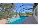 Screened pool and spa with brick pavers and tropical landscaping at 10656 Glencorse Ter, Bradenton, FL 34211