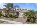 Single story house with a two-car garage, and palm trees at 11550 Blackfin St, Venice, FL 34292