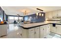 Kitchen boasts white cabinets, black appliances, and a breakfast bar at 1510 1St W Ave # 504, Bradenton, FL 34205