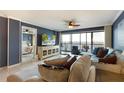 Bright living room with water views, comfortable furniture, and large TV at 1510 1St W Ave # 504, Bradenton, FL 34205
