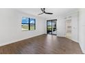 Bright bedroom with wood-look floors and sliding doors to patio at 17825 Gawthrop Dr # 104, Bradenton, FL 34211