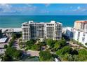 Beautiful aerial view of beachfront condo complex with lush landscaping and stunning ocean views at 1800 Benjamin Franklin Dr # A405, Sarasota, FL 34236