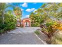 Single story house with a paver driveway and tropical landscaping at 235 Grant Dr, Sarasota, FL 34236