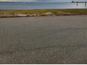 Asphalt road leading to a waterfront view at 2502 Riverside E Dr, Bradenton, FL 34208