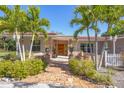 Brick walkway leads to a lovely front entry with palm trees at 2605 Desoto Rd, Sarasota, FL 34234