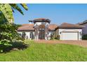 Beautiful home exterior showcasing a tile roof and lush landscaping at 4937 Oxford Dr, Siesta Key, FL 34242