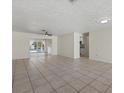 Spacious living room with tile flooring and access to the back patio at 5164 Windward Ave, Sarasota, FL 34242