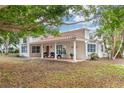 Front view of a single-story house with a covered porch and lush landscaping at 7705 Alhambra Dr, Bradenton, FL 34209