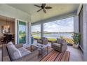 Relaxing covered patio overlooking a lake with comfortable seating at 8918 Barrier Coast Trl, Parrish, FL 34219