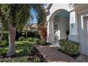 Front entry with walkway, landscaping, and arched entryway at 9203 Winter Harbour Way, Bradenton, FL 34212