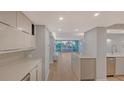 Modern kitchen with light cabinets, quartz countertops, and stainless steel appliances at 988 Blvd Of The Arts # 311, Sarasota, FL 34236