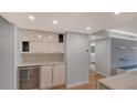 Modern kitchen with white cabinets and wine cooler at 988 Blvd Of The Arts # 311, Sarasota, FL 34236