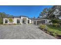 Modern home with a gray paver driveway and attached garage at 15125 Waterline Rd, Bradenton, FL 34212