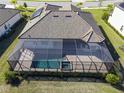 Aerial view of a home with a solar panel and screened pool and spa at 17539 Polo Trl, Bradenton, FL 34211