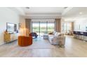 Bright and airy living room with large windows and stylish furnishings at 17539 Polo Trl, Bradenton, FL 34211