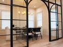 Bright dining room with arched glass doors and contemporary furnishings at 2311 Grove St, Sarasota, FL 34239